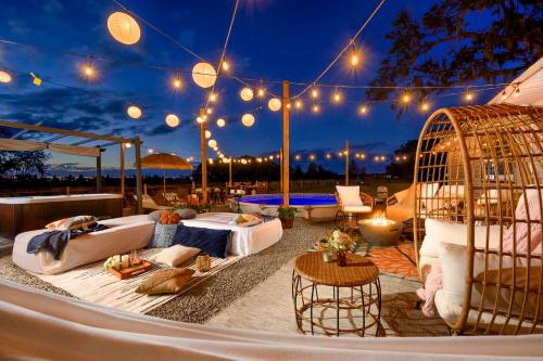 a patio with two beds and a bird cage at Plant City Home and Guest House with Outdoor Pool! in Plant City