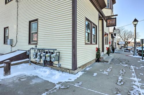 a building with two parking meters on the side of it at Delafield Vacation Rental Near Lakes and Parks! in Delafield