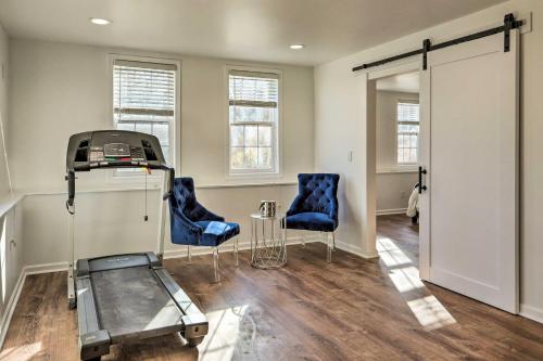 a room with two blue chairs and a machine at Atlanta-Area Retreat Near Lake Pet Friendly! in Peachtree City