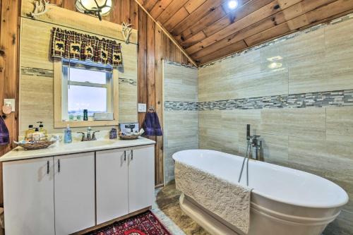 a bathroom with a tub and a sink at Lake Champlain Vacation Rental on Private Lot in Chazy