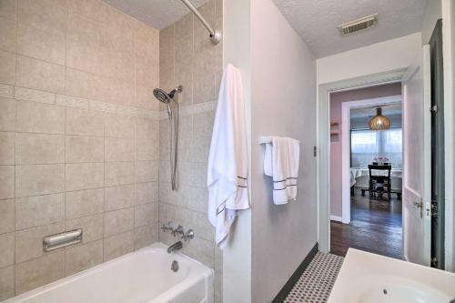a bathroom with a tub and a sink at Charming Historic Houston Home with Yard! in Houston