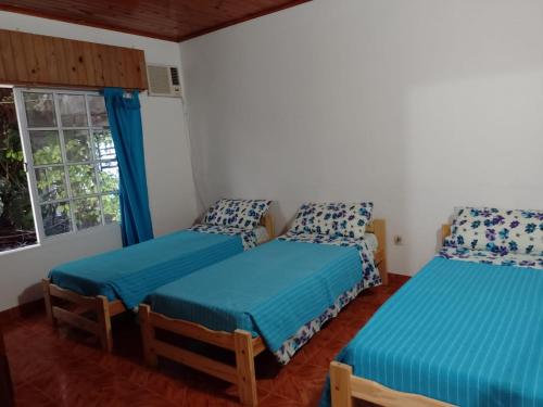 1 dormitorio con 2 camas individuales y ventana en Alojamientos Litoral - Casa Palma en Gualeguaychú