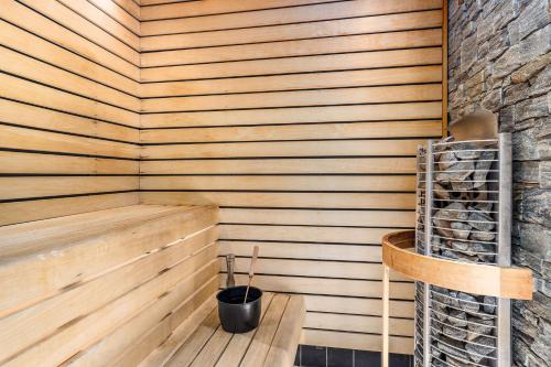 a sauna with a wooden paneled wall and a wooden bench at Best Western Hotel Baltic in Sundsvall