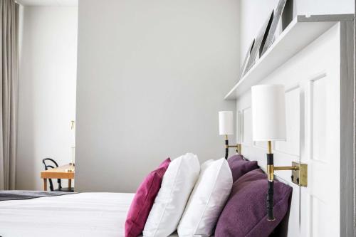 a bunch of pillows sitting on a bed at Best Western Hotel Baltic in Sundsvall