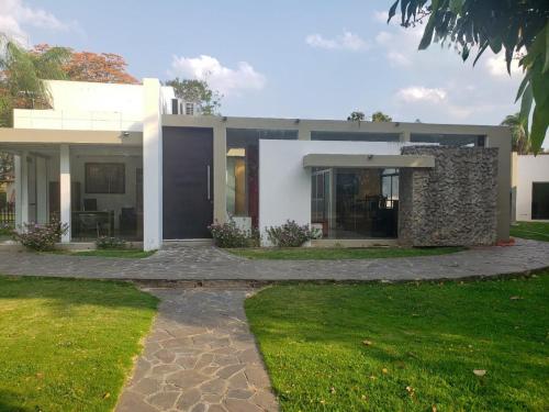 ein großes weißes Haus mit einer Steinmauer in der Unterkunft Casa Vida in Santa Cruz de la Sierra