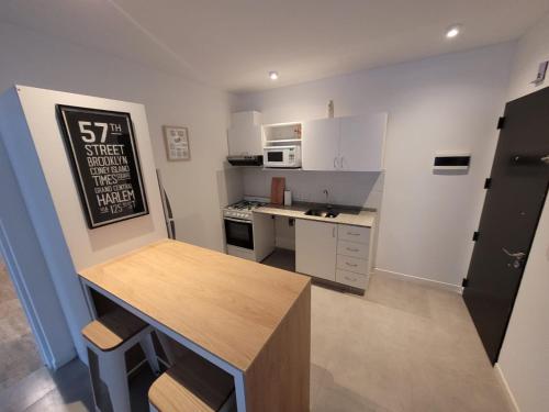 a small kitchen with white cabinets and a counter top at Miradores Sáenz Peña in Tigre