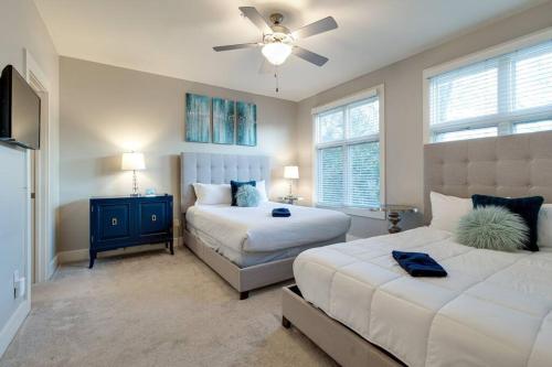 a bedroom with two beds and a ceiling fan at I luv Nash - Minutes from Broadway! in Nashville