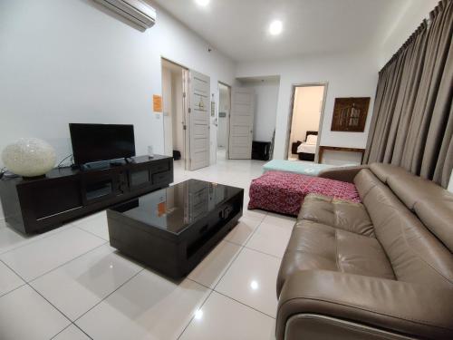 a living room with a couch and a television at My Daily Homestay - Miri Times Square in Miri