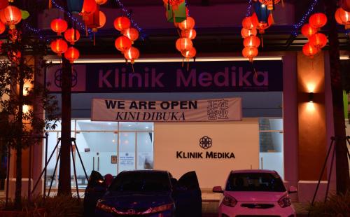 two cars parked in front of a kinks melaka store at My Daily Homestay - Miri Times Square in Miri