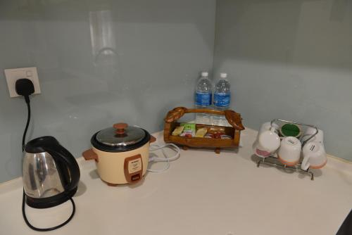 a counter top with a coffee pot and a toaster at My Daily Homestay - Miri Times Square in Miri