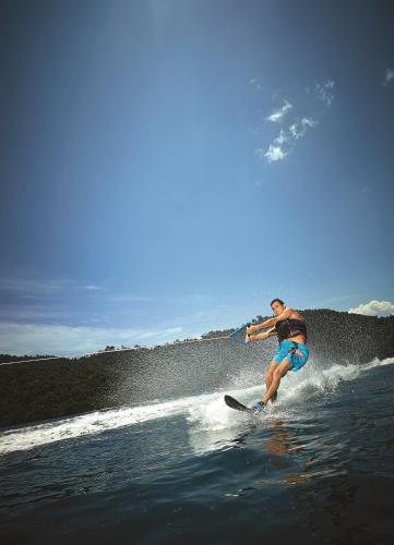 a man riding a wave on a surfboard in the water at Shangri-La Tanjung Aru, Kota Kinabalu in Kota Kinabalu