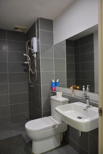 a bathroom with a toilet and a sink at My Daily Homestay - Miri Times Square in Miri