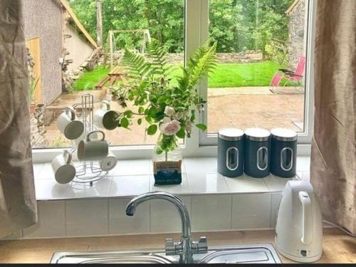 a kitchen counter with a sink and a window at Crag End Farm Retreat, Rogerscale, Nr Cockermouth in Lorton