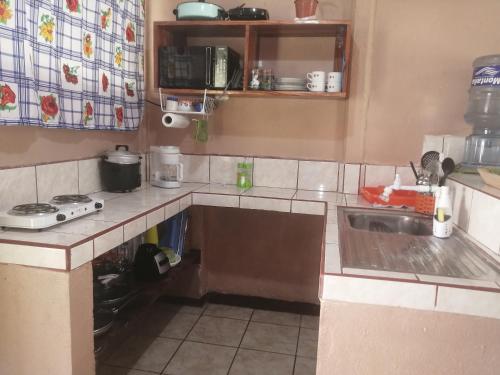 a kitchen with a sink and a counter top at BRIKE Apartamento in Puerto Jiménez