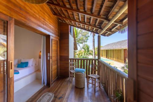 a balcony of a villa with a bedroom and a bed at Café Jeri Hotel - Adults Only in Jericoacoara