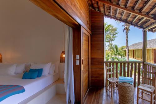a bedroom with a bed and a balcony at Café Jeri Hotel - Adults Only in Jericoacoara