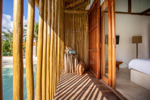 a room with a bedroom with a bed and a pool at Café Jeri Hotel - Adults Only in Jericoacoara