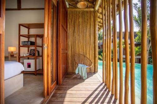 a room with a bed and a swimming pool at Café Jeri Hotel - Adults Only in Jericoacoara