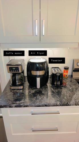 a kitchen counter with a coffee maker and a toaster at Queen bedroom in Windsor