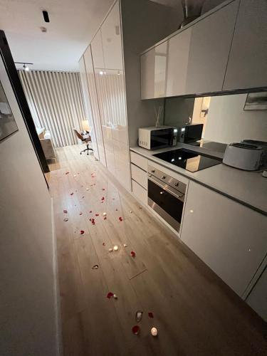 a kitchen with a floor with red petals on it at Ellipse Apartment in Midrand
