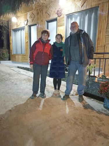 a group of three people standing in front of a building at Thao Ly Homestay Mai Chau in Hòa Bình