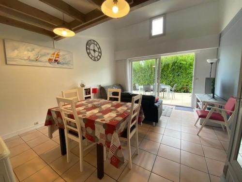 une cuisine et une salle à manger avec une table et des chaises dans l'établissement Maison 3 ch. à Royan avec jardin, WIFI et animaux acceptés - FR-1-494-143, à Royan