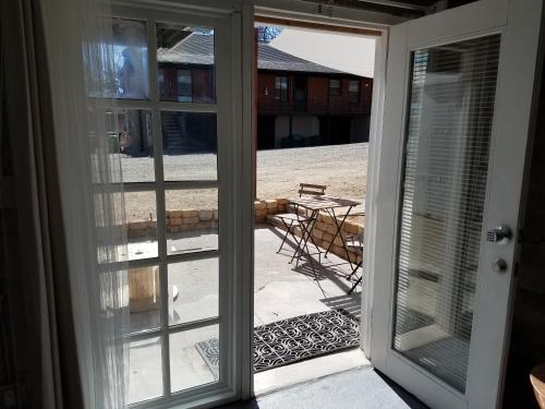eine offene Tür zu einer Terrasse mit einem Tisch und Stühlen in der Unterkunft Modern lofty studio in Midtown / Charming Old SW in Reno