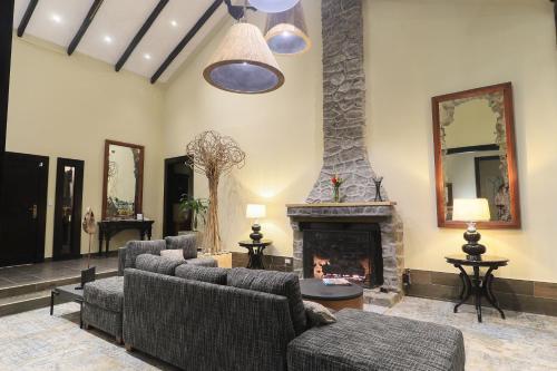a living room with couches and a fireplace at The Riverside Inn in Boquete
