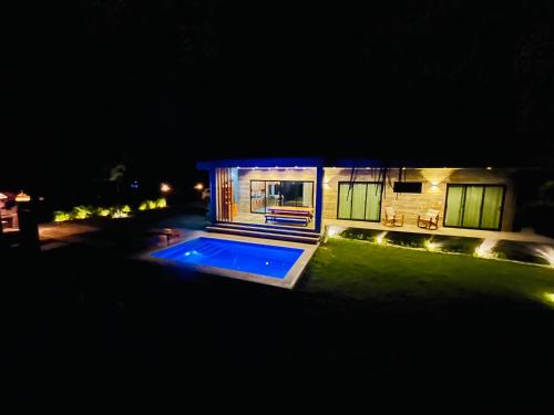 a house with a swimming pool at night at Casa Carmela 