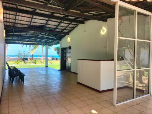 a lobby with a view of the ocean at Hotel Coral Bay in Trincomalee