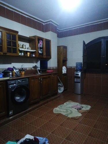 a kitchen with a washer and dryer on the floor at شقه فندقيه للايجار ثلاث غرف in Cairo