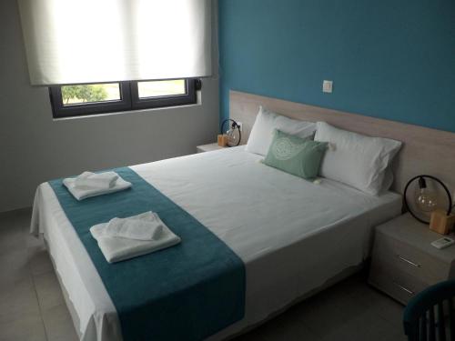 a bedroom with a large bed with towels on it at Triopetra View 2 in Triopetra