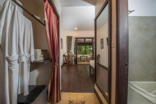 a bathroom with a walk in shower and a tub at Marirath Boutique Hotel in Siem Reap