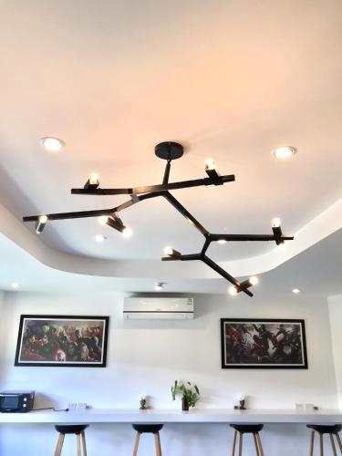 a chandelier in a dining room with a table at Stardust Boutique Hotel in Hua Hin