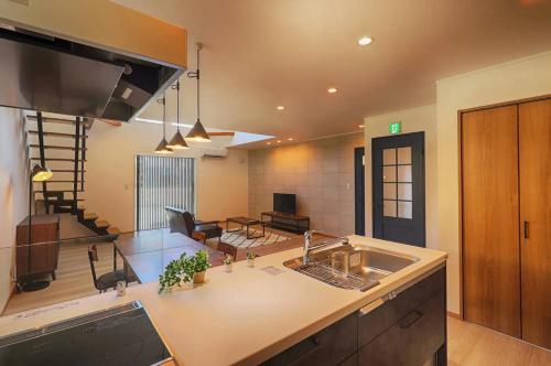 a kitchen with a sink and a living room at ヴィラ ザ・キューブVilla The Cube Fuji view Annovillas in Fujikawaguchiko