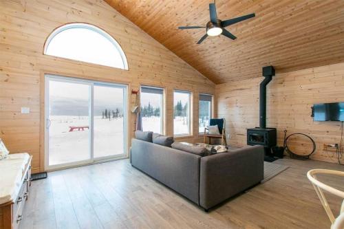 a living room with a couch and a ceiling fan at **WATERFRONT**BEAUTIFUL MODERN TOBERMORY COTTAGE in Miller Lake