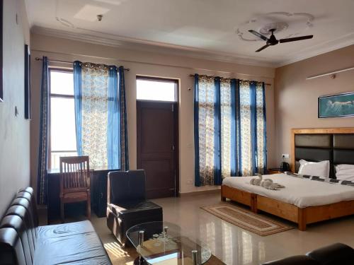 a bedroom with a bed and a living room at Yoga House in McLeod Ganj