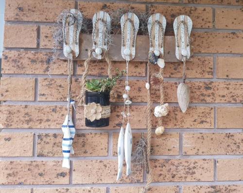 a wall with a bunch of utensils hanging on it at Seascape in Forster