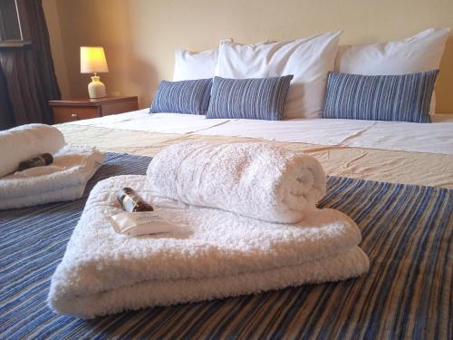a hotel room with a bed with towels on it at Thiamis Guesthouse in Doliana