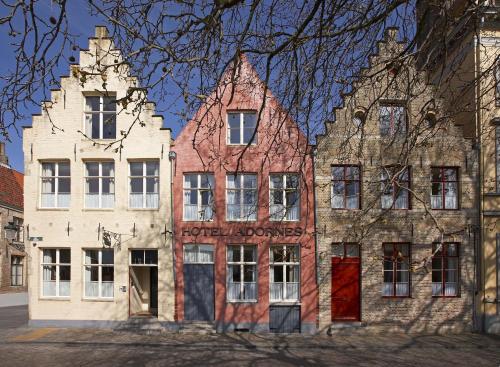 an old building in the middle of a street at Hotel Adornes in Bruges