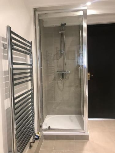 a shower with a glass door in a bathroom at The Smithy in Richmond