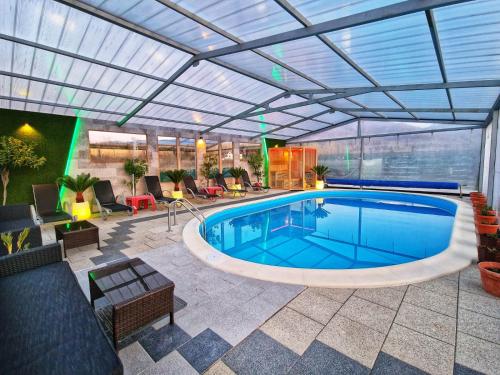 a swimming pool in a patio with a roof at Cabana Supporter -Supporter Chalet in Porumbacu de Sus