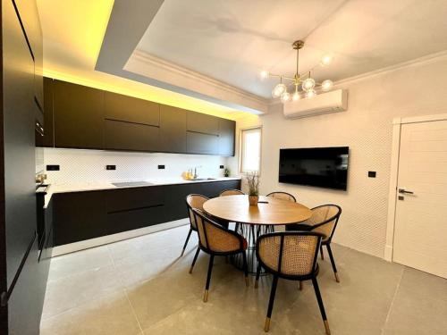 a kitchen with a table and chairs in a room at Beautiful 4-Bedroom Townhouse in Sliema in Sliema