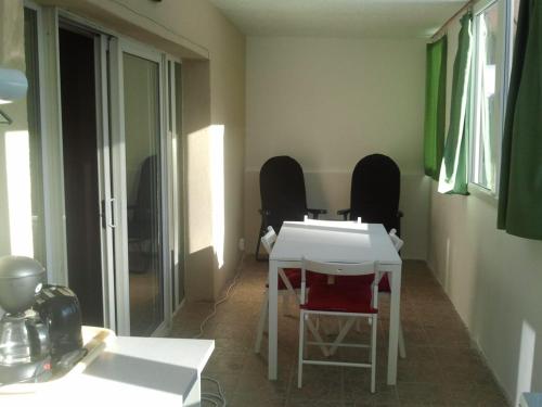 a room with two chairs and a white table at Casa Oriana in Predeal