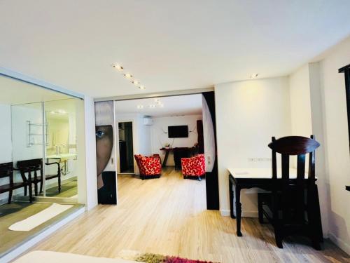 a living room with a table and a dining room at Baipho Lifestyle in Patong Beach