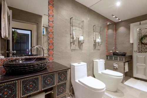 a bathroom with a toilet and a sink at Baipho Lifestyle in Patong Beach