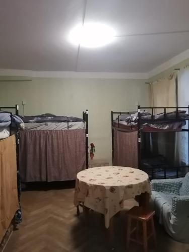a room with two bunk beds and a table at El Hostal in Tbilisi City