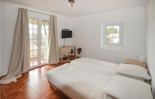 a white bedroom with a bed and a window at Awesome Home In La Gaude With Kitchen in La Gaude