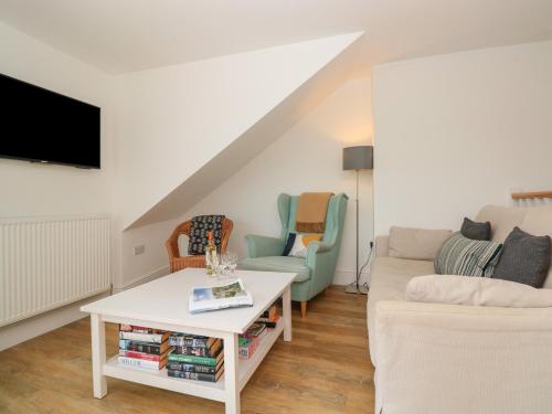 a living room with a couch and a tv at Seaview in Dartmouth