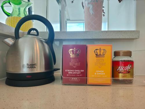 a tea kettle sitting on a counter next to some candles at Stunning view close to everything in Gold Coast